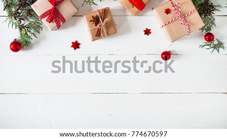 Christmas or New Year background, plain composition made of Xmas decorations,  gift, and fir branches, flat lay, blank space for a greeting text
