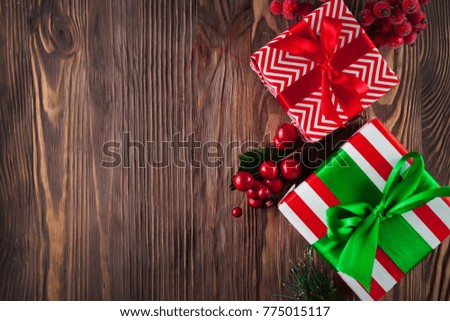 Christmas gift box with decoration. Gifts boxes on wooden background top view
