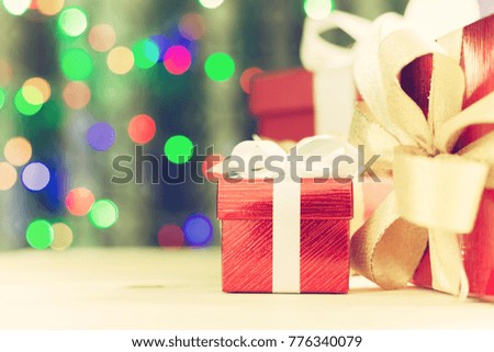 Christmas gifts boxes or new year presents on wooden table and bokeh lights background