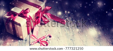 Christmas presents with holidays dacoretions on wooden background in vintage style
