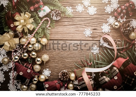 festive background concept with christmas decorating items on wooden background with light filter