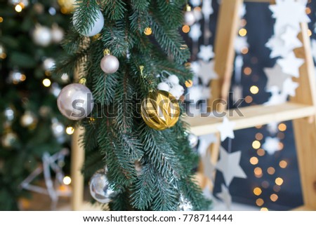 gold and silver Christmas decorations on the tree 