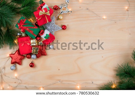 Top view Gift box and Christmas decorations and ornaments on wooden background
