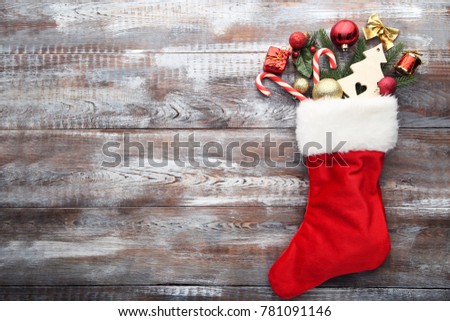 Red stocking and christmas decorations on wooden table