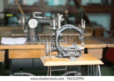Ancient sewing machine on the table