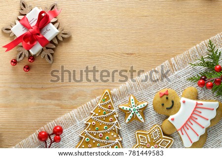 Christmas gingerbread,gift, different decorating and gift  lie on a wooden table of  with napkin. Color foto.
