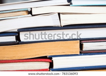 Stack of books background. many books piles. Books and reading are essential for self improvement, gaining knowledge and success in our careers, business and personal lives