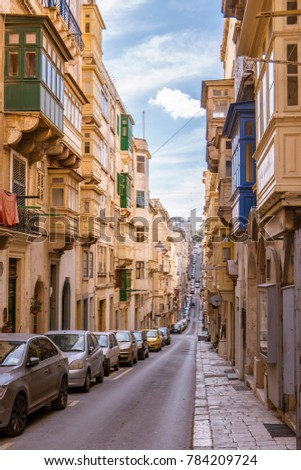 Typical narrow streets with colorful balconies in Valletta