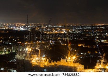 Outdoor panoramic scenic view of Jomtien, Pattaya , Thailand at night showing numerous skyscrapers consists of building under construction and other colorful bright fluorescent and sport lights