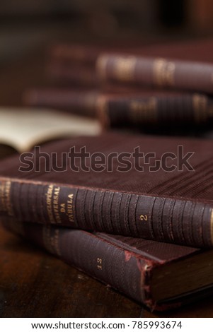 Old books on rustic wooden table. Stack of books. Background blurred. Scenery rustic, brown and warm.