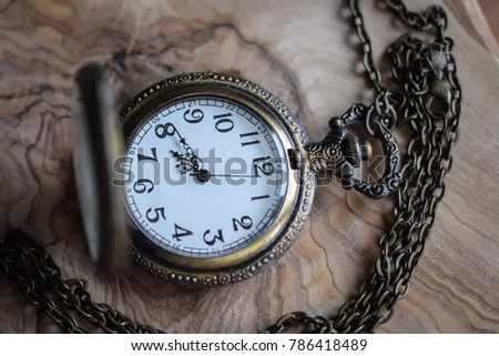 Old pocket watch on wooden background
