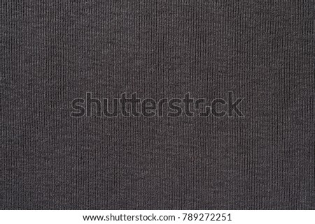Closeup photo of vertical textile texture. Dark gray color. High resolution