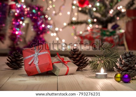 Beautiful Christmas background for a cheerful mood!Spices for hot New Year's Eve drink, Branches of Christmas trees, cones and Gift Boxes on a red background.