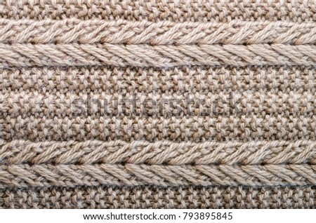 Knitted texture. Pattern fabric made of wool. Background, copy space.
