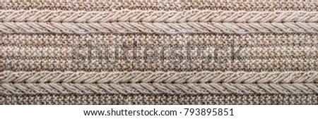 Knitted texture. Pattern fabric made of wool. Background, copy space. Banner.