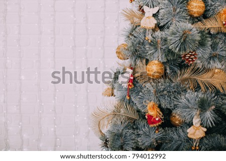 Christmas tree, stand next to candles and other holiday decorations