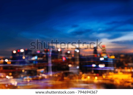Abstract background from blurred cityscape at night with twilight sky after sunset with bokeh. Picture for add text message. Backdrop for design art work.