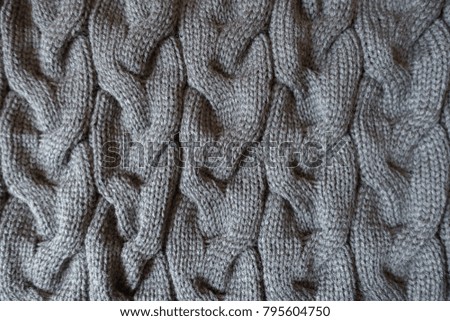 Vertical plaits on dark grey knit fabric