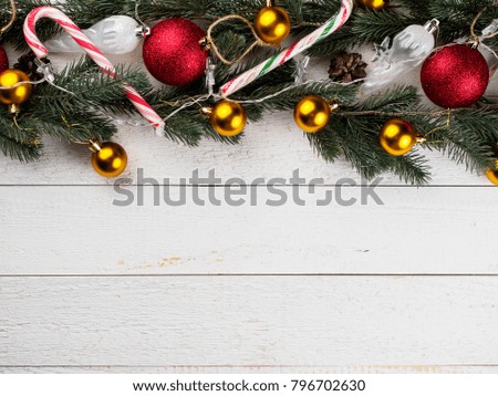 Christmas spruce branch wreath on the wood board.