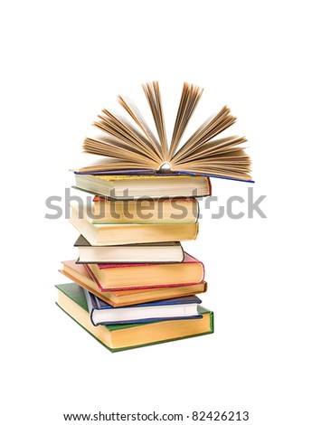 open book on a pile of books closeup isolated on white background