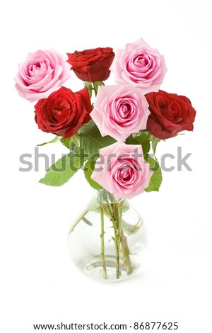 Bunch of red and pink roses in vase isolated on white