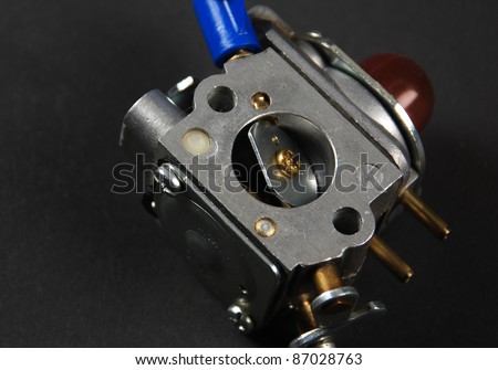 Stock pictures of a small gas engine and a carburetor