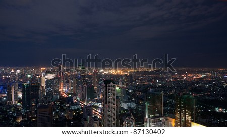 Bangkok Metropolis in Thailand at night with the Sathorn business and financial district in the foreground.