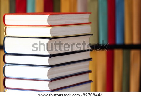 Stacked books and bookshelves; multicolored collection of books