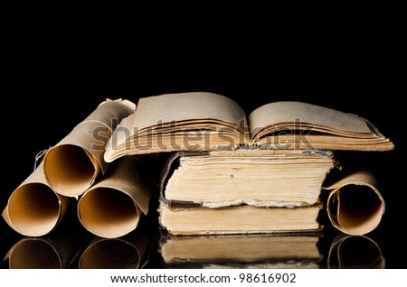 Many ancient scrolls and books on black
